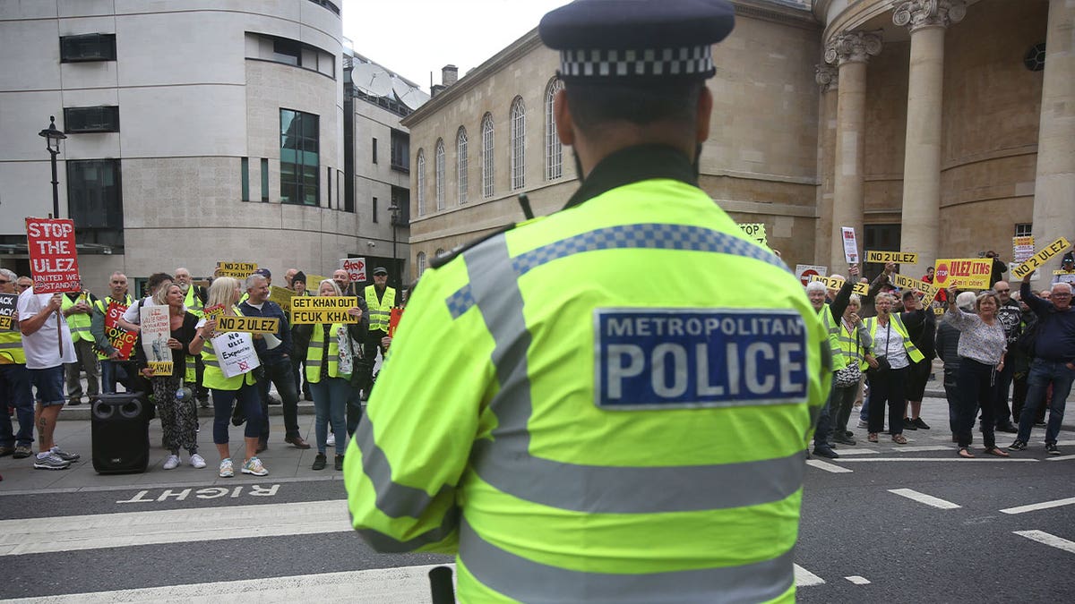 police officer watches protesters