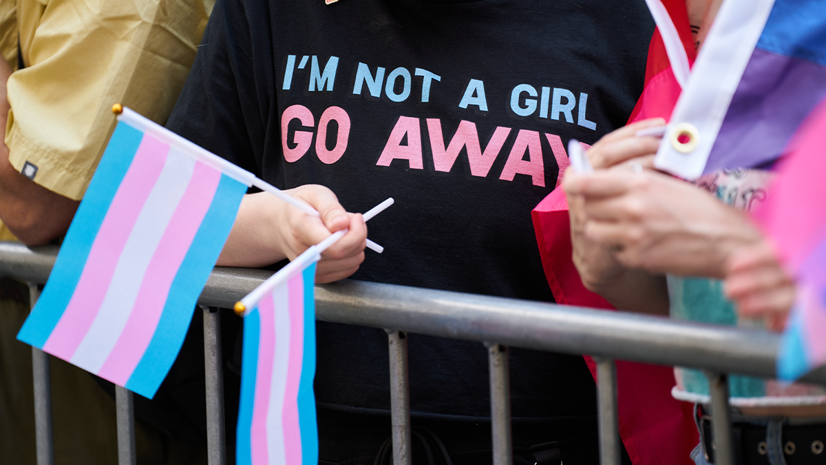 T-shirt on attendee at NYC pride march reading "i'm not a girl go away"