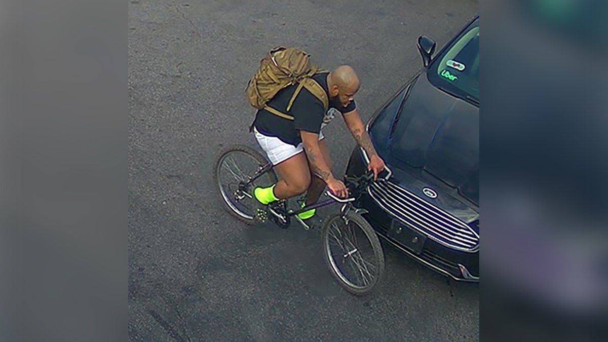 Suspect Michael Brooks II rides a bicycle