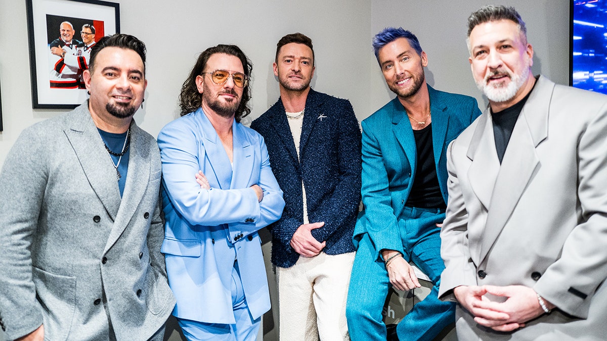 The members of NYSNC (L-R) Chris Kirkpatrick in a grey suit, JC Chasez in a light blue suit, Justin Timberlake in a navy suit, Lance Bass in a turquoise suit and Joey Fatone in grey hang out backstage at the VMAs.