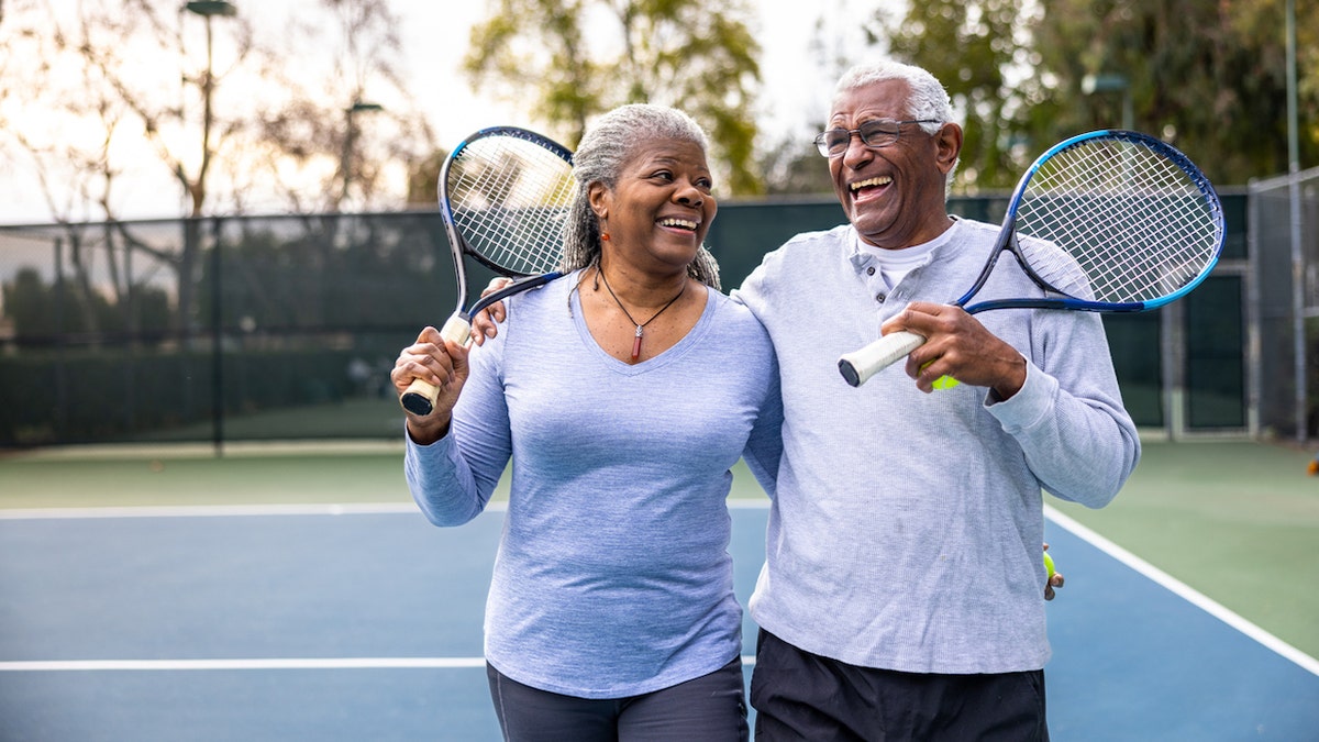 Older couple playing tennis
