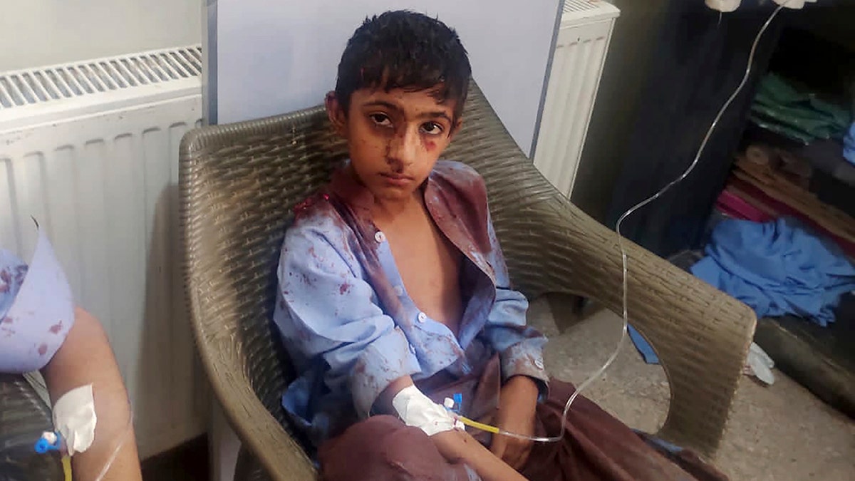 A boy injured in a bomb explosion receives medical treatment