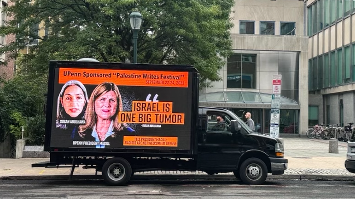 black truck painted with "israel is one big tumor"