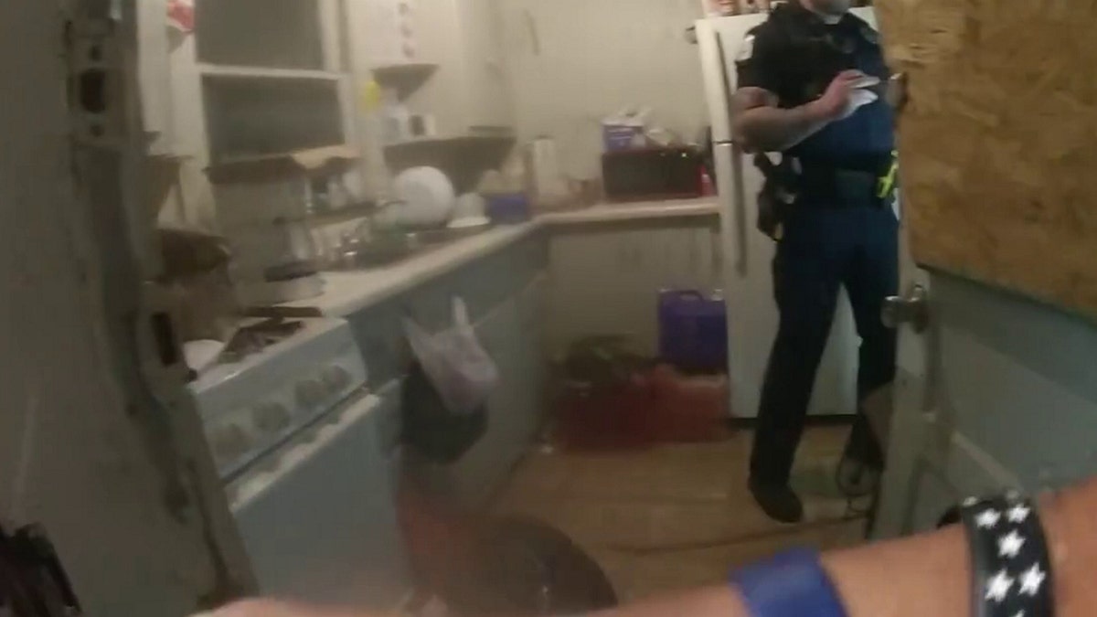 Police officers rescue people from house fire