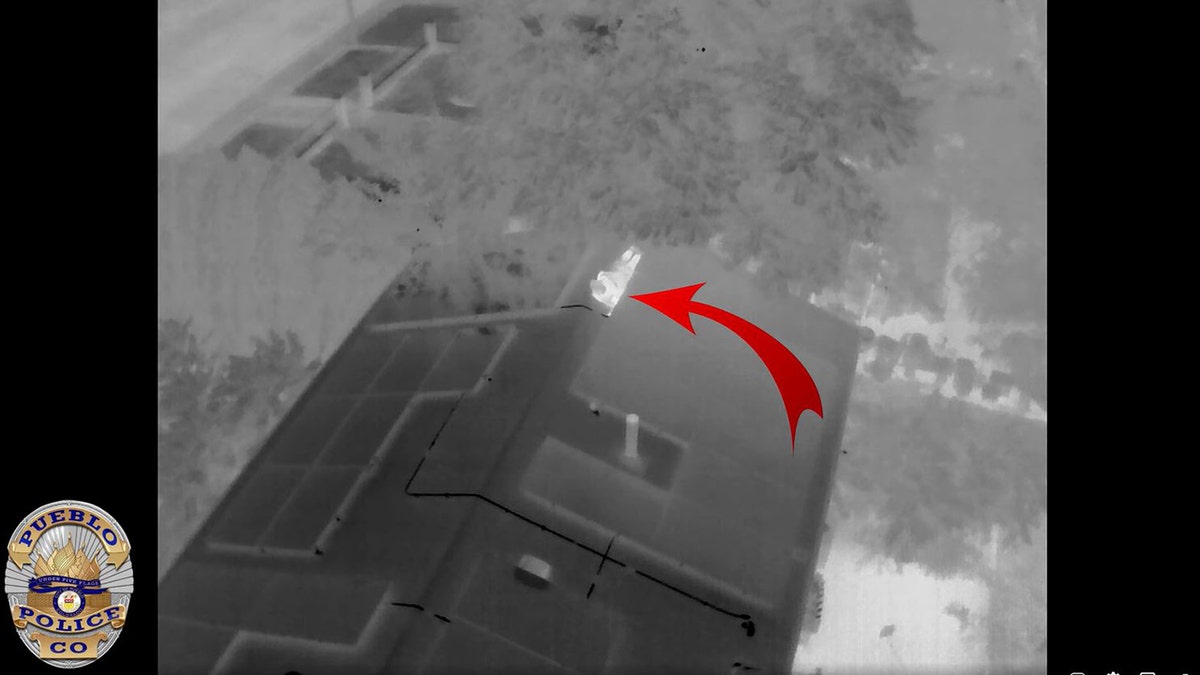 Arrow points at a suspect on top of a roof in Colorado