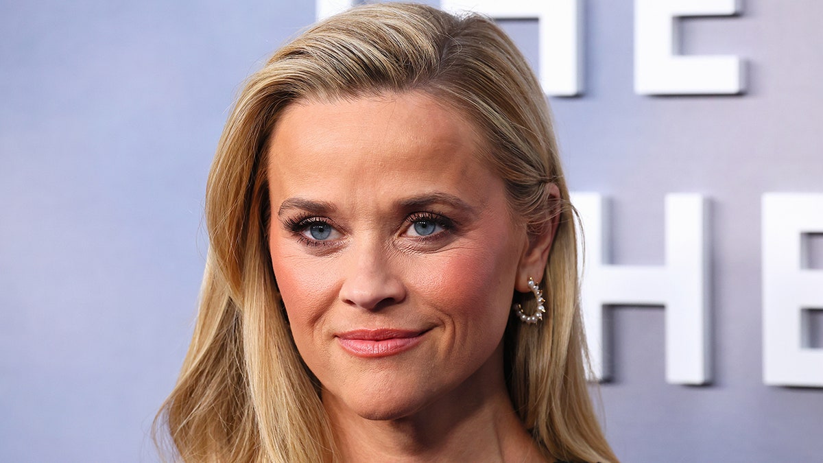 Reese Witherspoon soft smiles on the carpet at the LA premiere of "The Last Thing He Told Me"