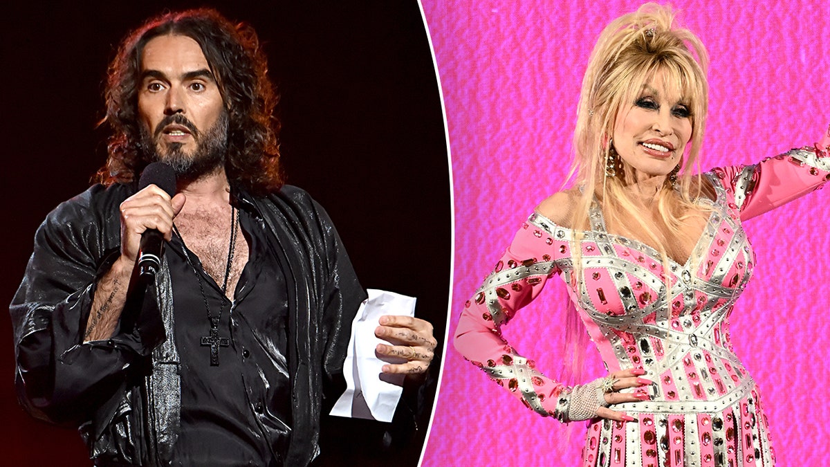 Russell Brand on stage in a black leather jacket and shirt speaking into a microphone split Dolly Parton in a pink and silver dress waves to audience