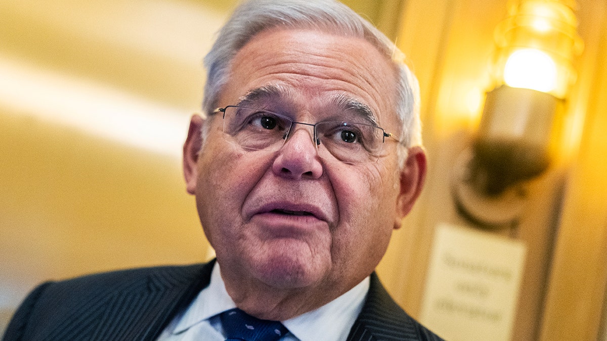 Sen. Menendez walks through the Capitol building in a suit.