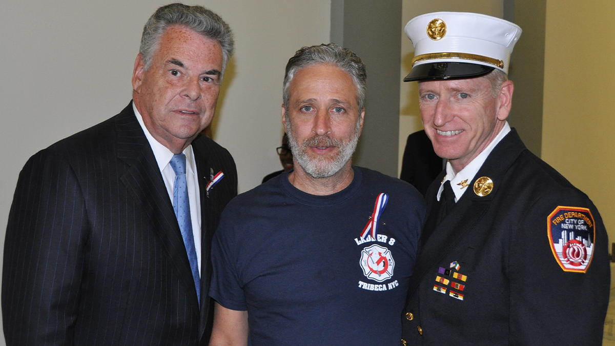 Jon Stewart, center, Richard Alles right, Rep. Peter King, left