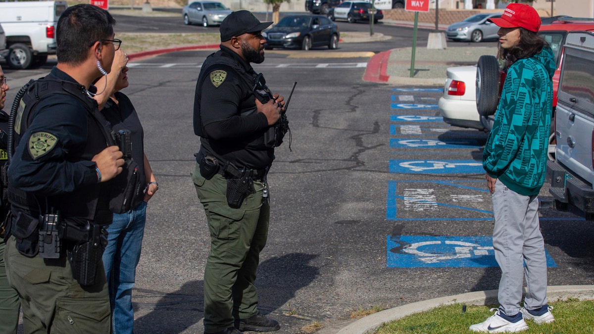 Police officers confront Ryan Martinez moments before he allegedly shot a man at a protest in New Mexico