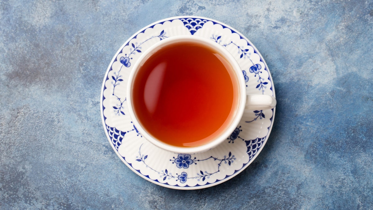 Cup of tea on a blue stone background. Copy space. Top view.