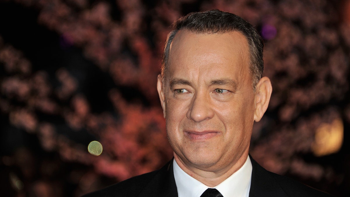 Tom Hanks smiling in suit