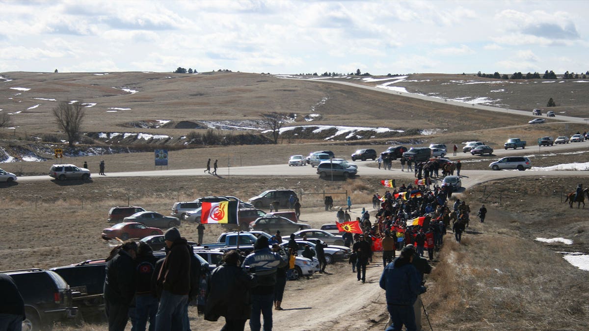 Members of the American Indian Movement walk to the Wounded Knee Massacre Monument on Feb. 27, 2013, in Wounded Knee, S.D. 
