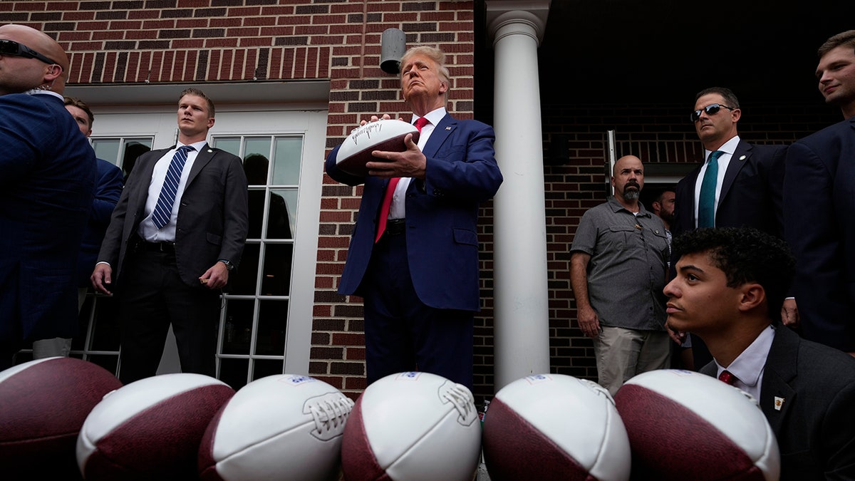 Trump in Iowa holding a football