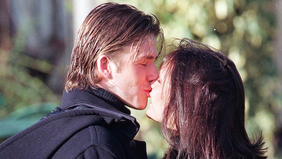 Victoria and David Beckham kissing in 1998