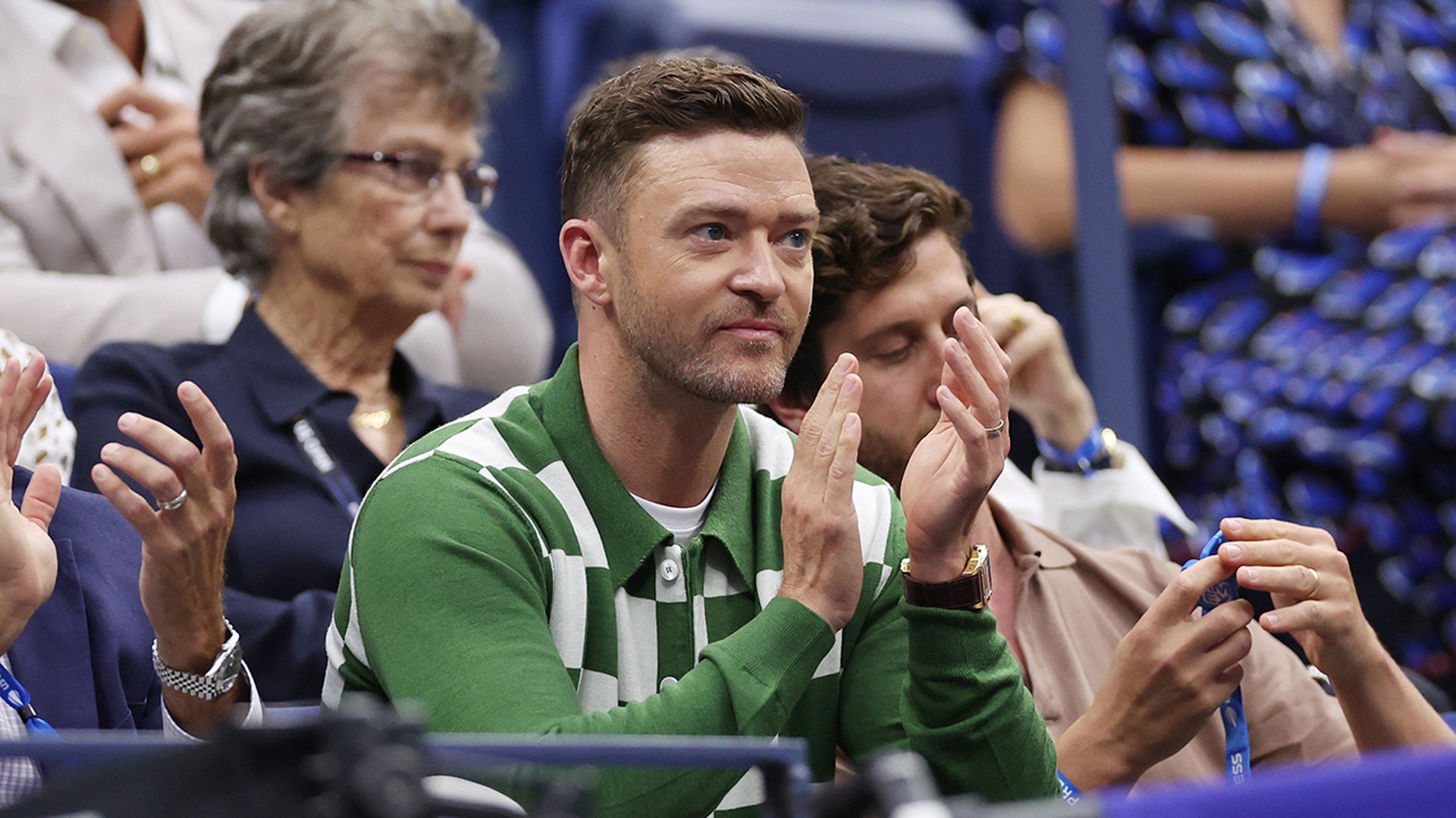 Justin Timberlake rocks green checkered sweater at US Open tennis game.