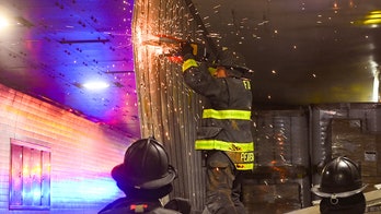 NYC firefighters seen cutting apart truck that got wedged in tunnel, causing traffic nightmare