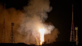 Soyuz docks at International Space Station with two Russians, one American