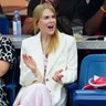 Nicole Kidman in a pink dress and white blazer claps while watching the US Open