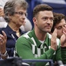 Justin Timberlake rocks green checkered sweater at US Open tennis game.