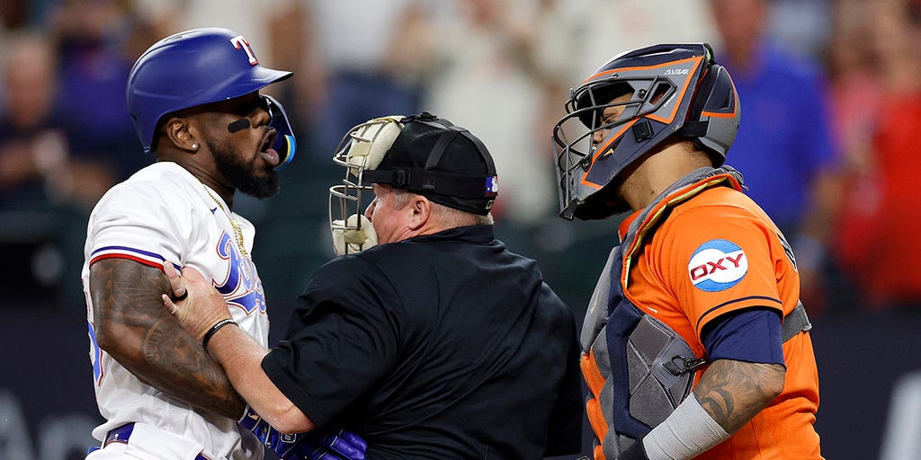 Adolis Garcia of the Texas Rangers fields a ball during the first