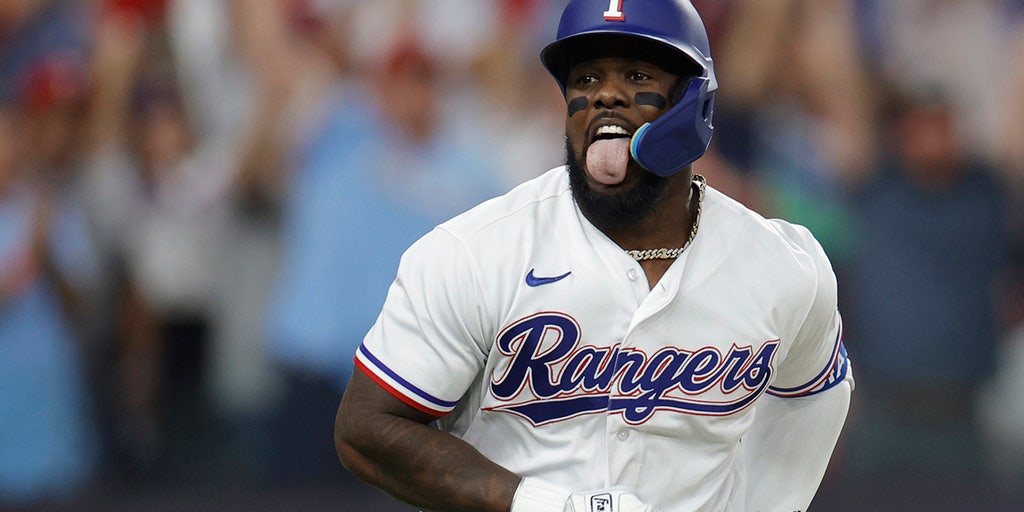 Adolis Garcia of the Texas Rangers fields a ball during the first