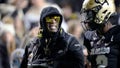 Colorado coach Deion Sanders, left, talks to quarterback Shedeur Sanders, his son, during the first half of the team's NCAA college football game against Stanford on Friday, Oct. 13, 2023, in Boulder, Colo. ()