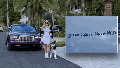 Olga Benyo, 41, struts in front of her purple Rolls-Royce with a matching purse and belt,  before a pair of brazen thieves stole it from her Miami garage. Her husband flew a banner offering a reward to track down the $250,000 luxury coupe.