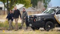 Authorities walk outside a closed funeral home where 115 bodies have been stored, Friday, Oct. 6, 2023, in Penrose, Colo.