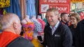 New Zealand Prime Minister Chris Hipkins greets residents on the street in Auckland, New Zealand, Friday, Oct. 13, 2023.