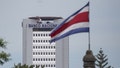 The Costa Rican national flag flies in front of Banco Nacional headquarters, San Jose, Costa Rica, Friday, Aug. 12, 2022.