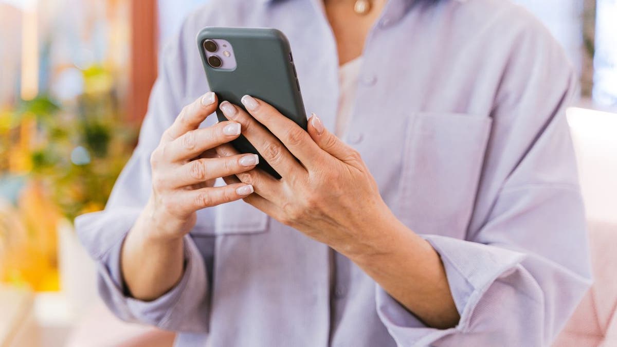 iPhone user holding the device