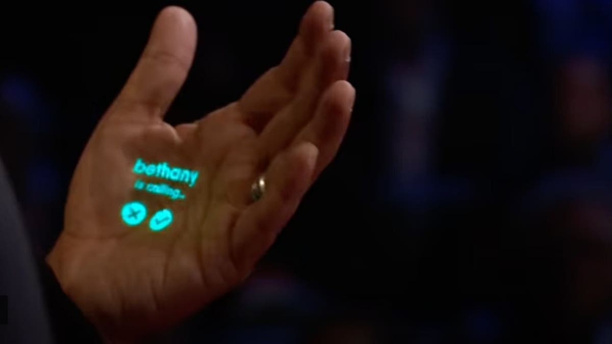 Person with a projection on their hand.