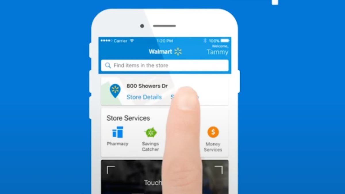 Walmart app and someone pressing the screen with their finger.