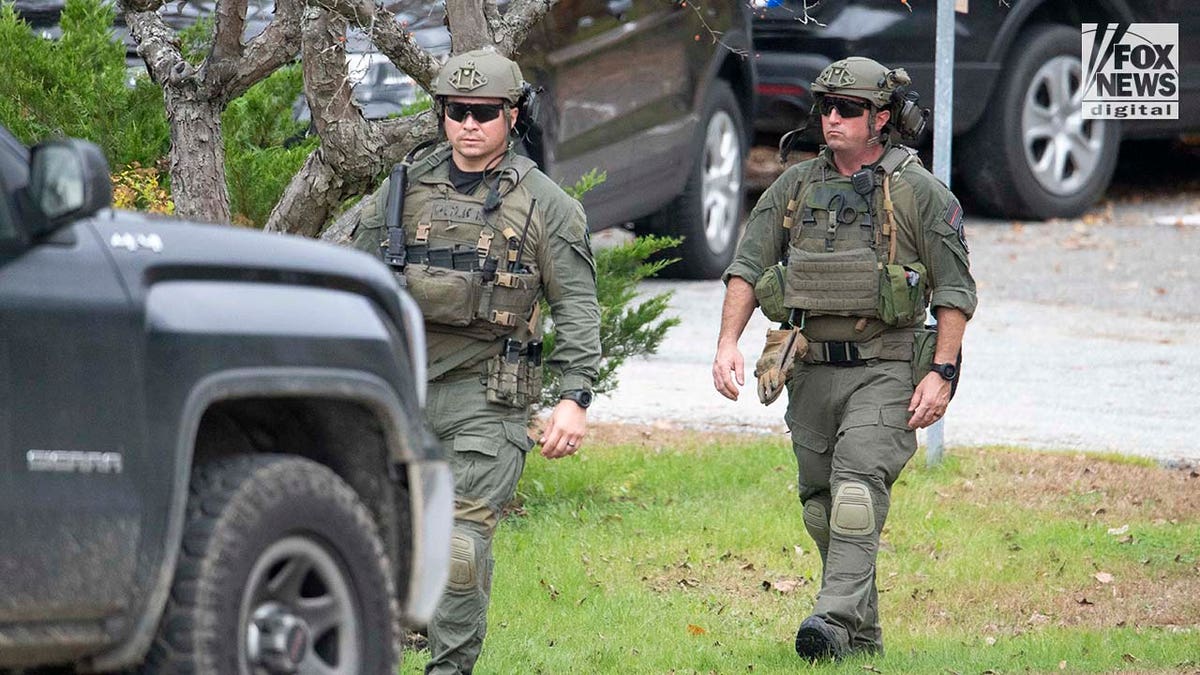 Law enforcement agents aid in the search for Robert Card along the Androscoggin River