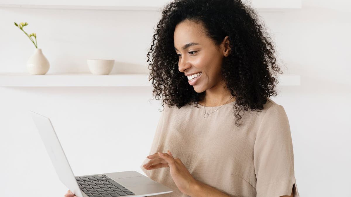 Woman typing on her laptop.