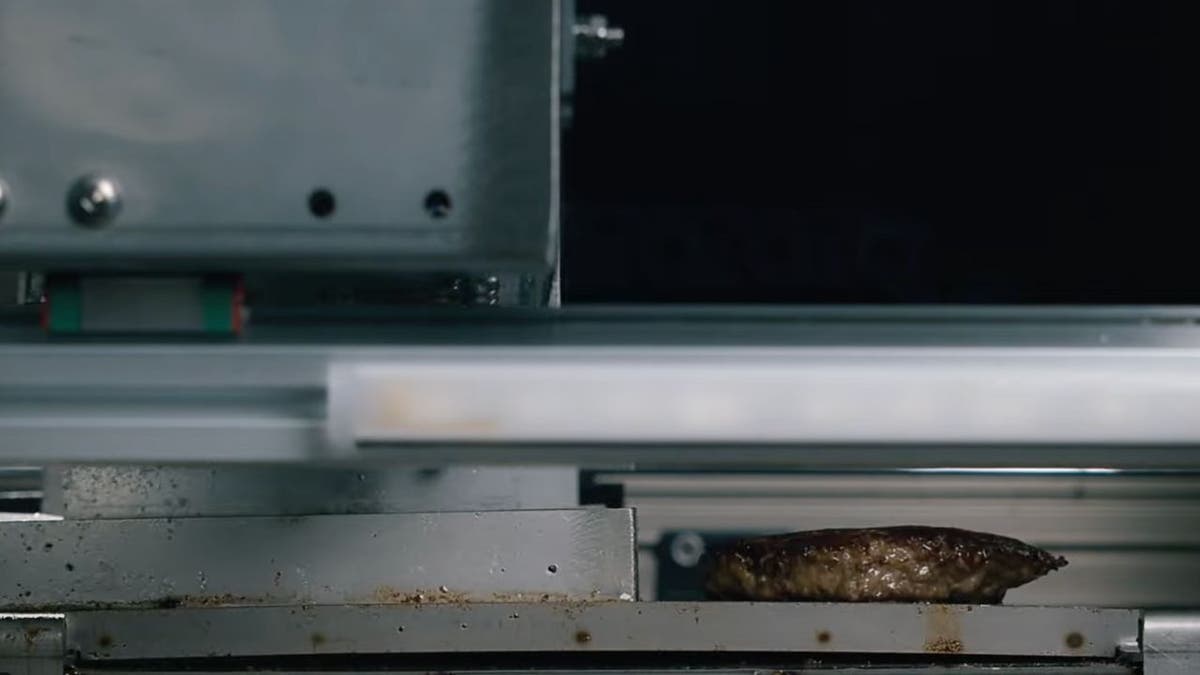 Photo of the hamburger patty cooking in the Alpha Grill.