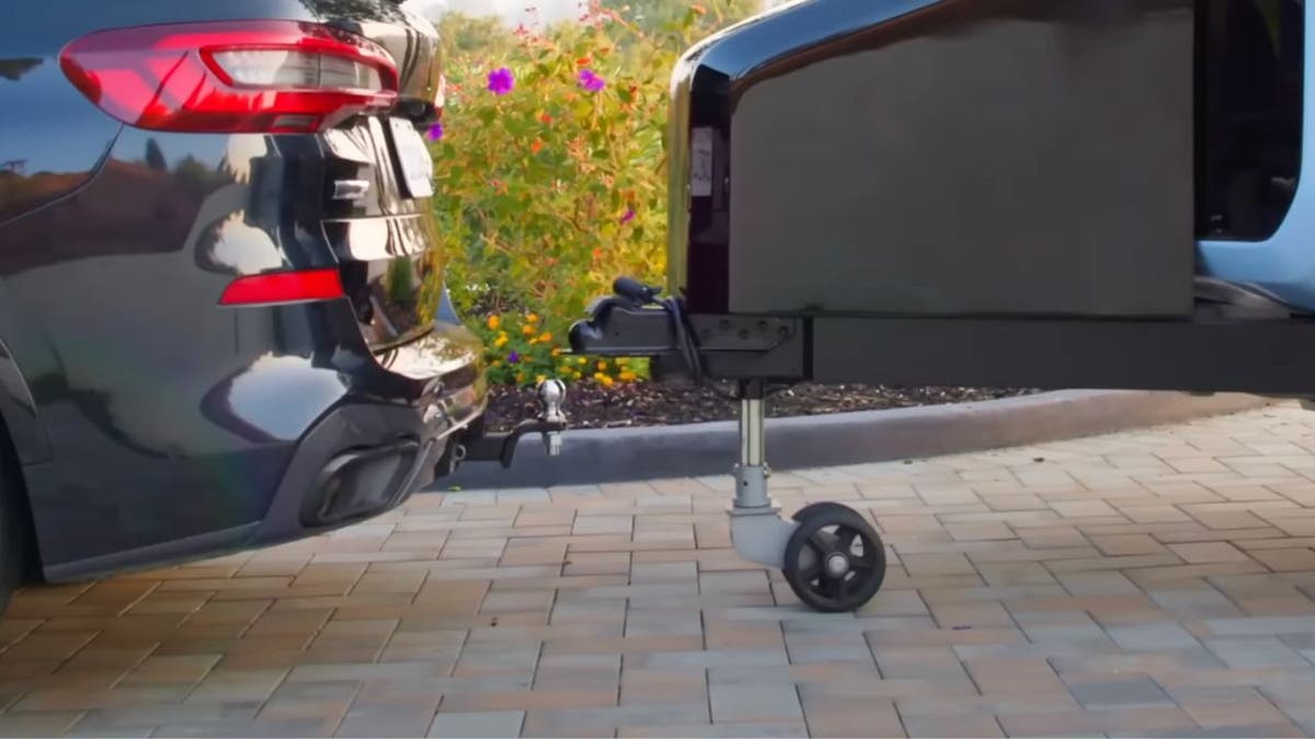 The Pebble Flow hitched to a car.