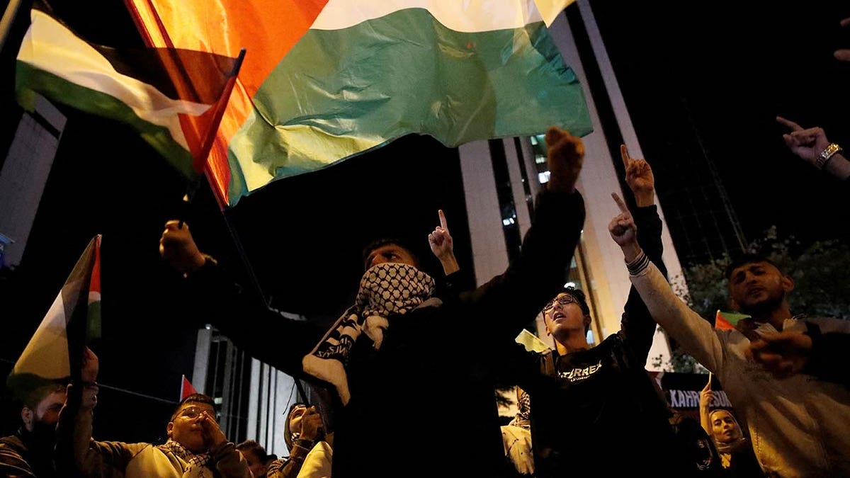 Pro-Palestinian demonstrators shout slogans during a protest near the Israeli Consulate