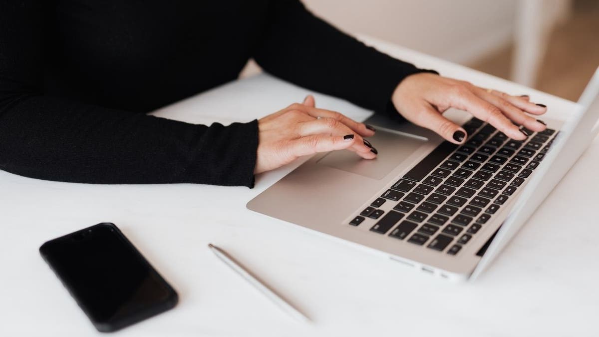 Woman typing on her laptop.