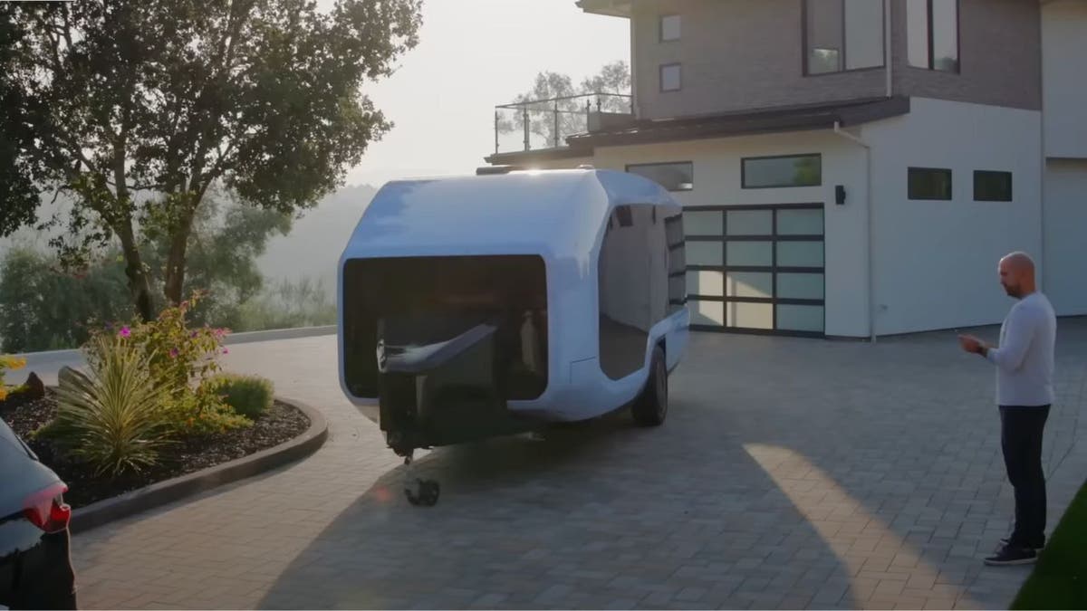 Photo of the camper in a driveway.