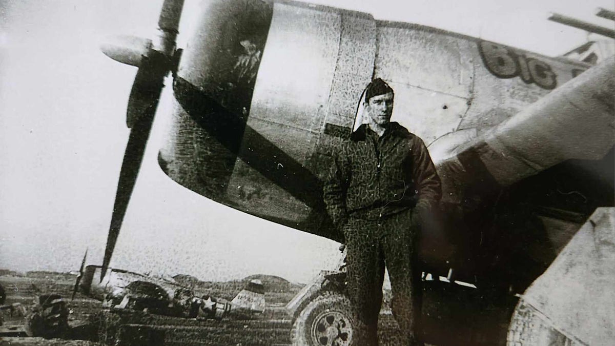 Wally king stands in front of airplane