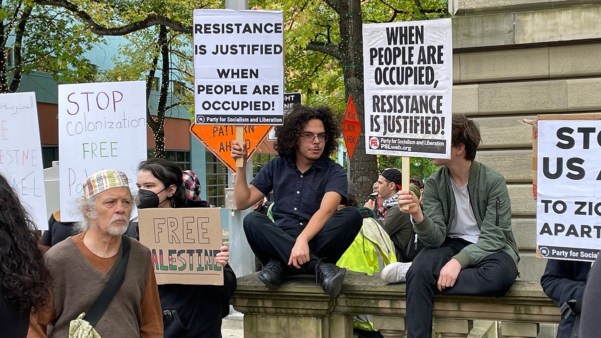 Crowd of pro-Palestinian protesters with signs outside Portland City Hall