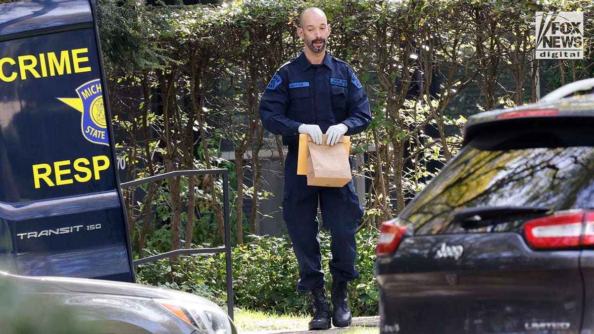 Michigan State Police Crime Scenes Unit compile evidence outside of Samantha Woll's home