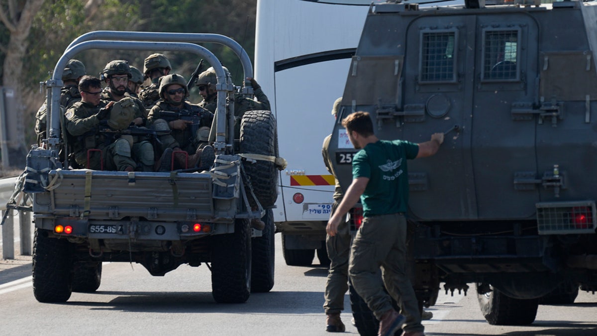 Israel forces roll out in military vehicles