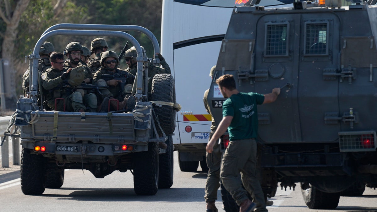 Israel forces roll out in military vehicles