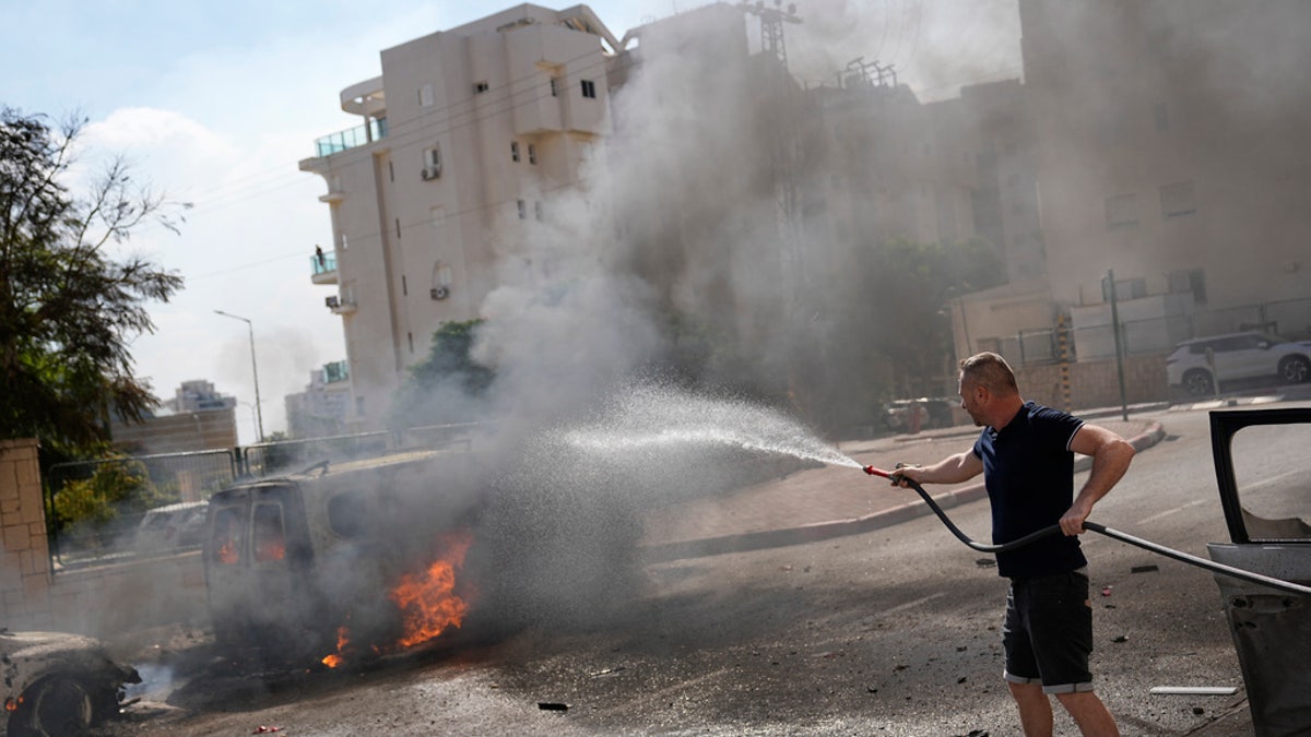 Cars burn after being hit by rockets fired from the Gaza Strip in Ashkelon, Israel, on Oct. 7, 2023.