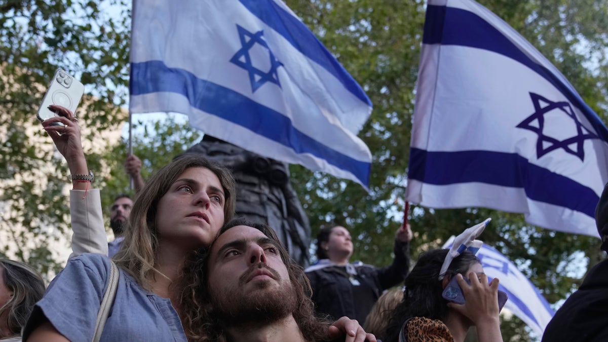 vigil attendees with Israel flags