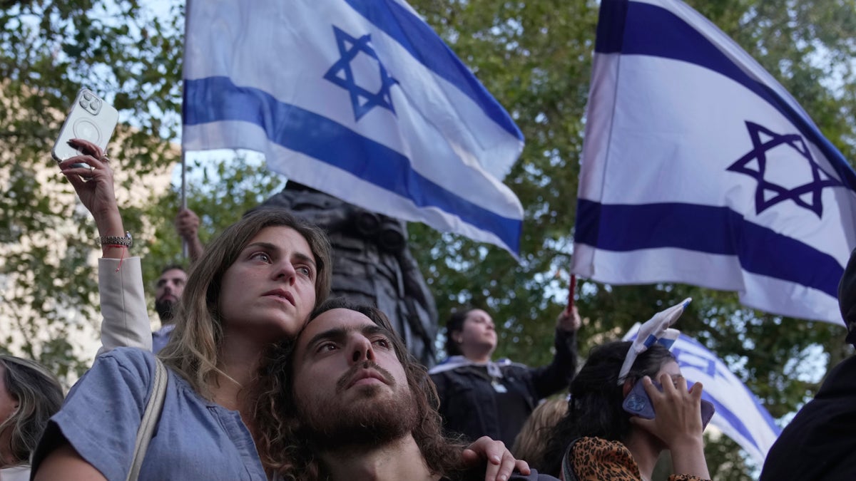 vigil attendees with Israel flags