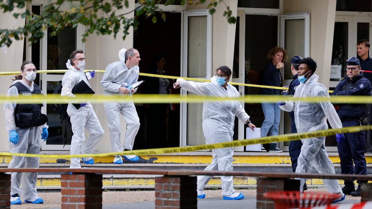 Forensic investigators in protective suits at the school crime scene